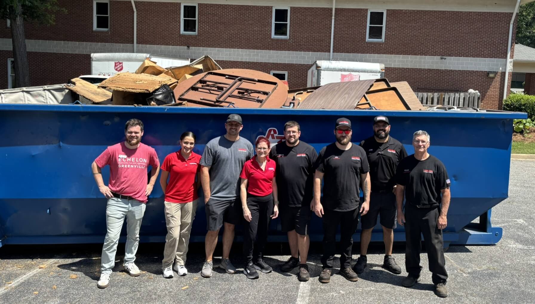 Carolina Handling team outside dumpster. 